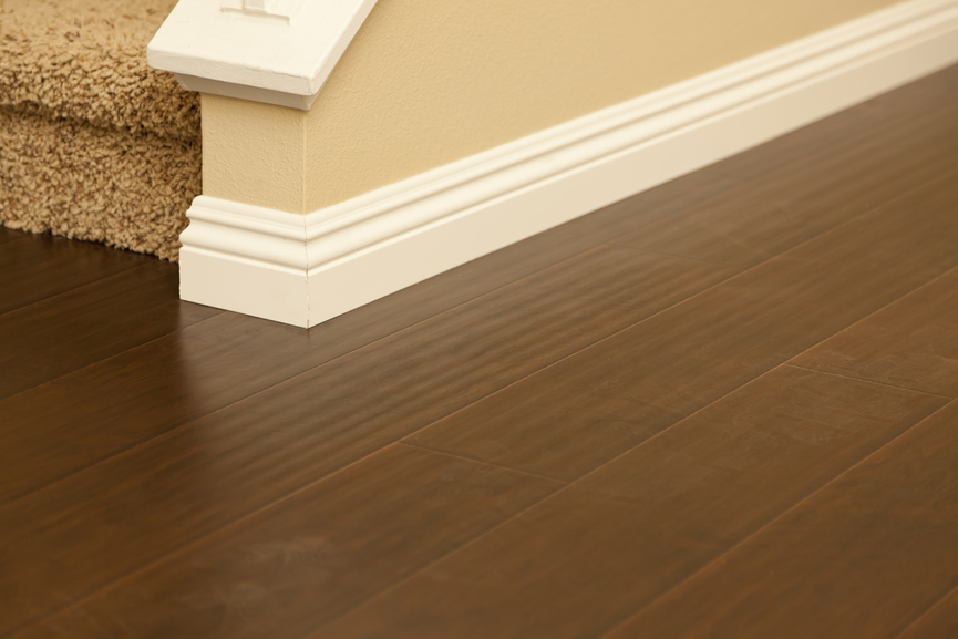 Beautiful Newly Installed Brown Laminate Flooring and Baseboards in Home.