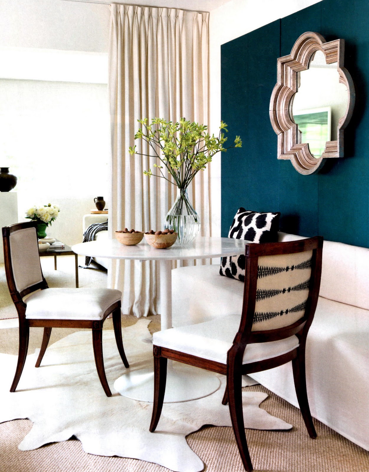 lindsey-bond-turquoise-wall-cowhide-rug-quatrefoil-mirror-tuliptable-banquette-seating