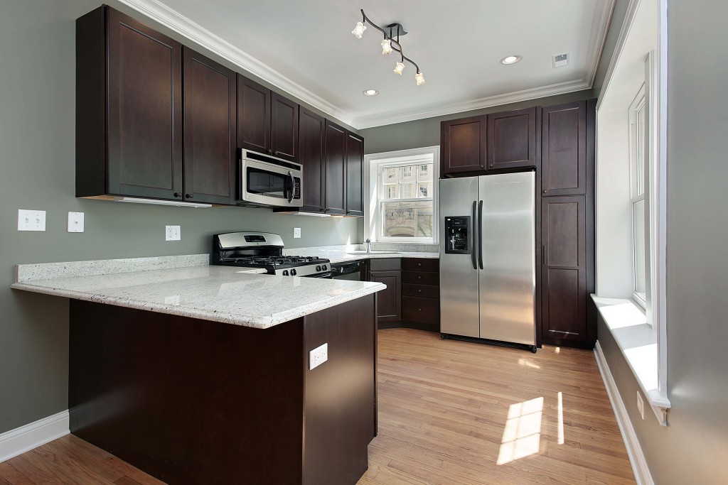 Kitchen in remodeled condominium unit mahogany cabinetry