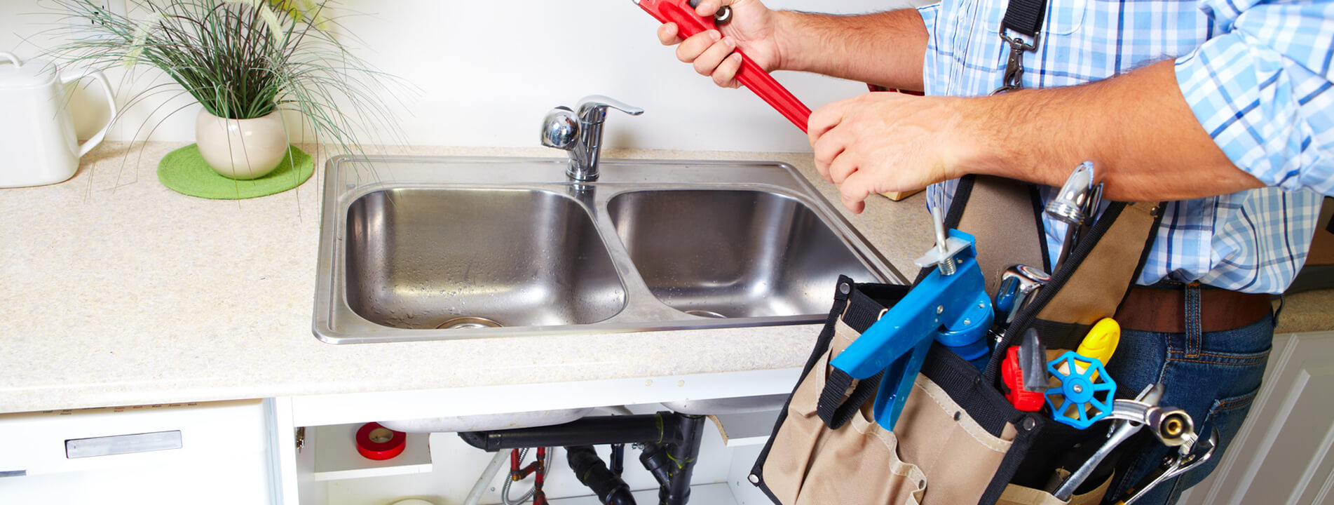 plumber fixing kitchen sink