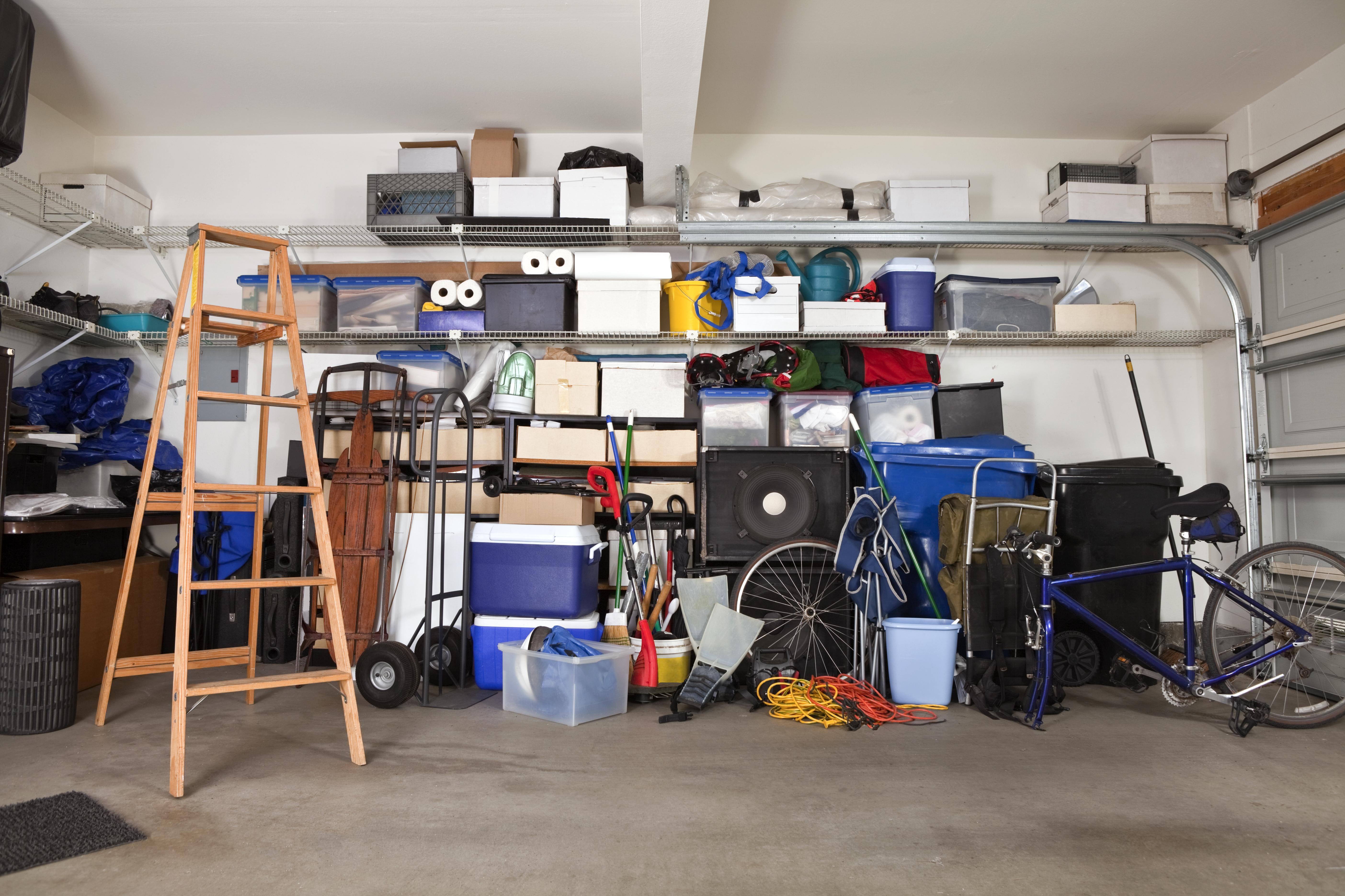 suburban garage mess with boxes, tools and toys in disarray
