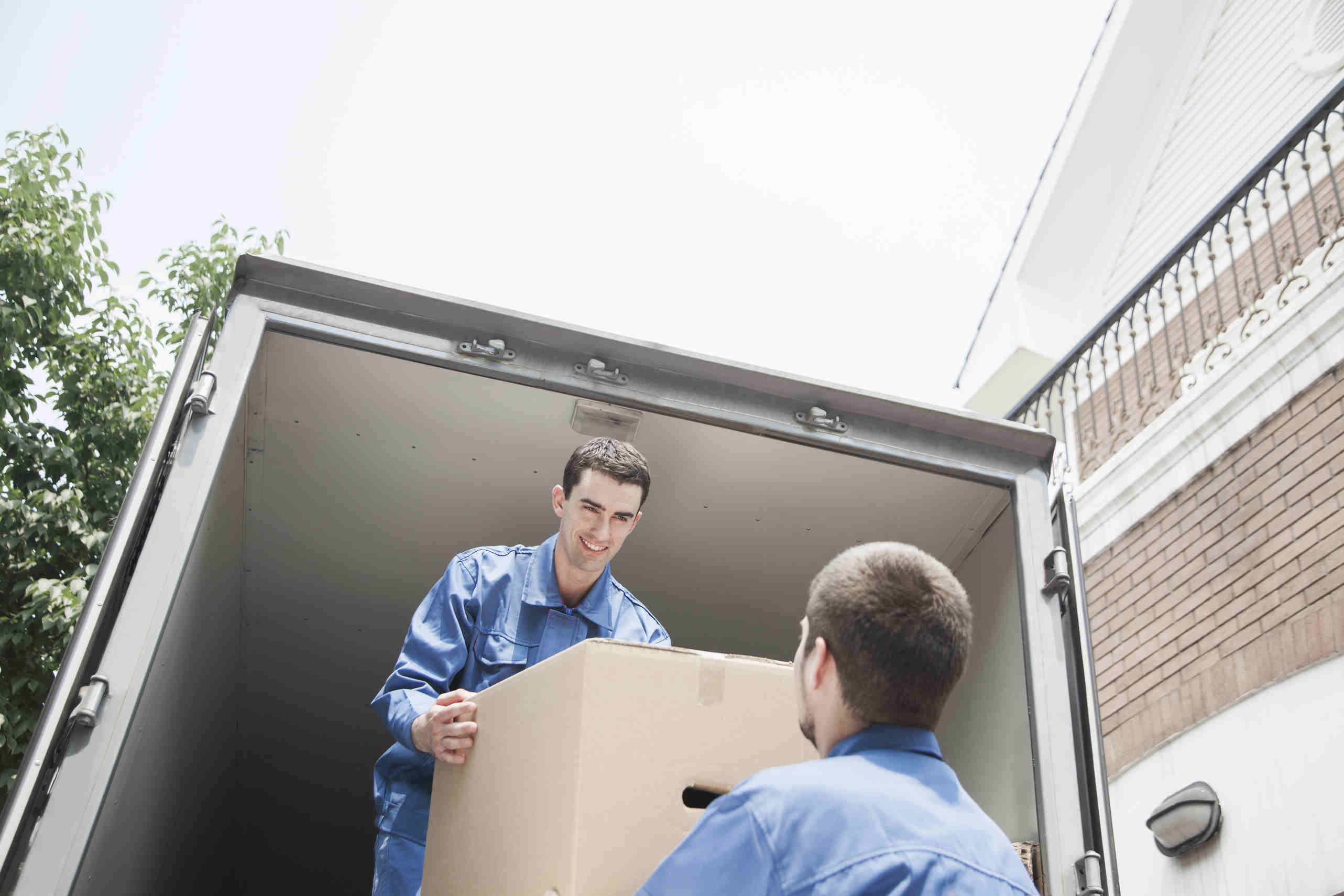 removalist men loading box onto truck