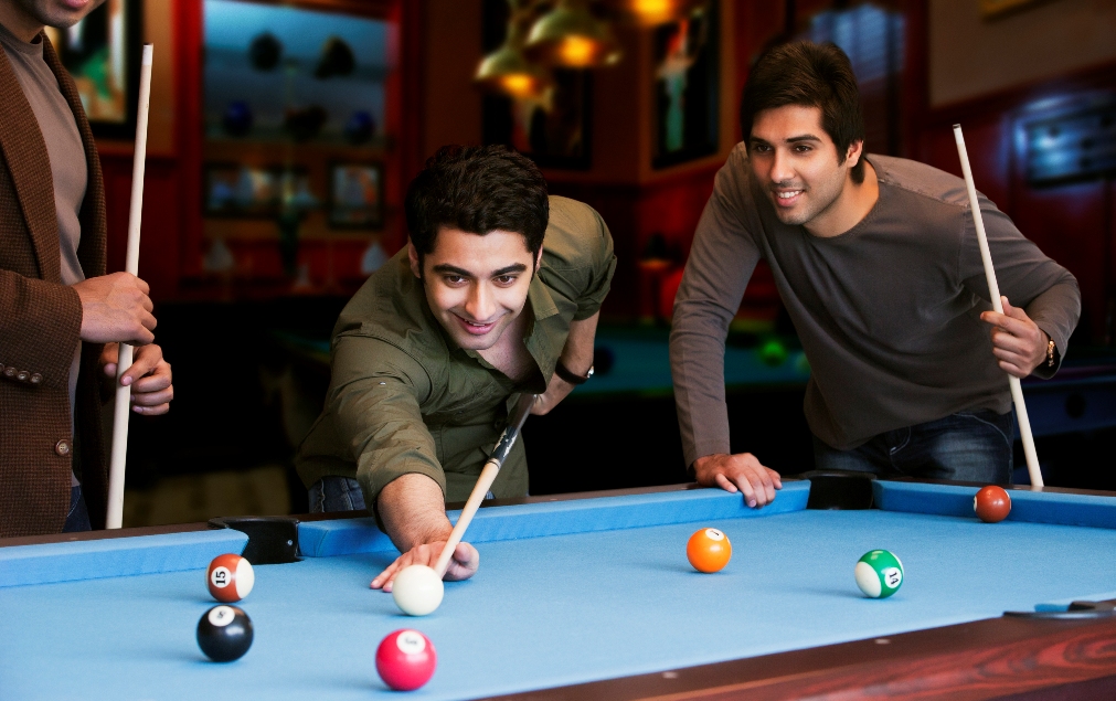 pool game among friends in man-cave