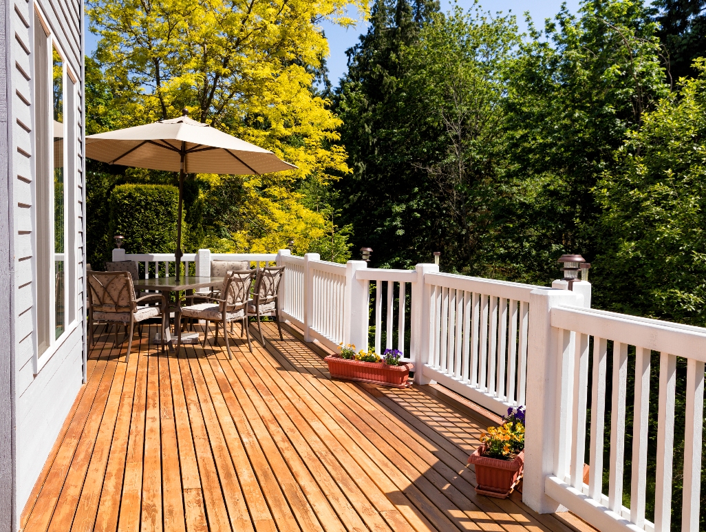 home outdoor cedar deck with furniture and open umbrella during nice bright day