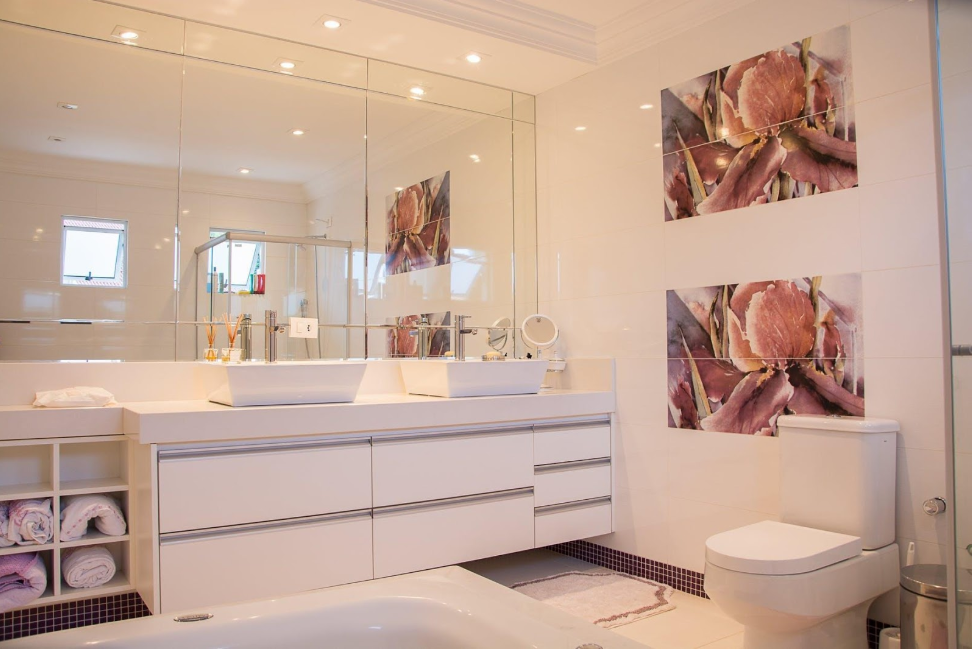 bathroom with large mirrors ceramic basins and artwork