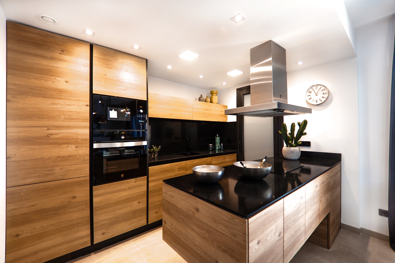 kitchen with black counter wood panels white walls