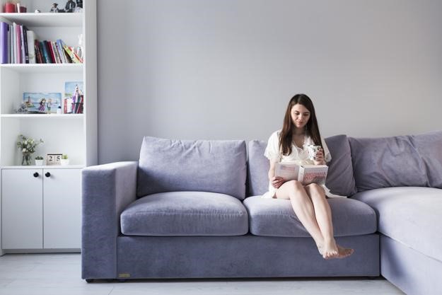woman sitting on living room couch