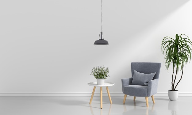 living room with grey chair white table plant and pendant light