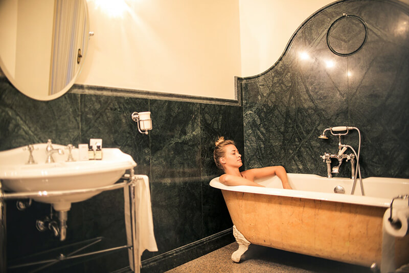 period style bathroom with vintage tub and bathroom fixtures