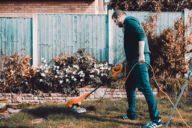 man mowing grass on lawn