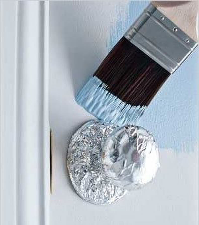 Door Painting Hack painting a door with knob wrapped in aluminum foil