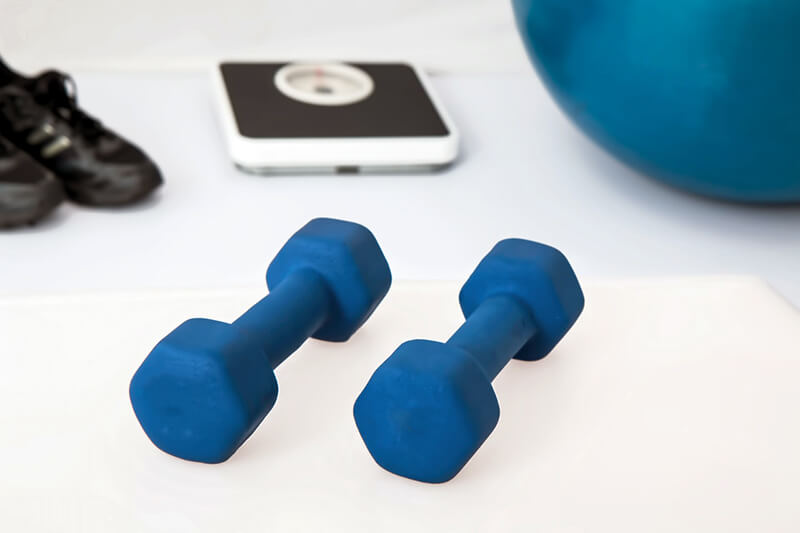 Home Gym Gear blue dumbbells, pilates, rubber shoes, and weighing scale