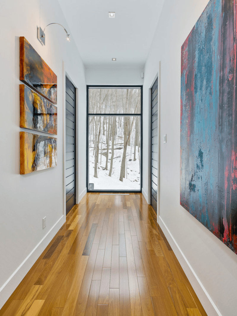 modern hallway, wood floor, natural light, artwork