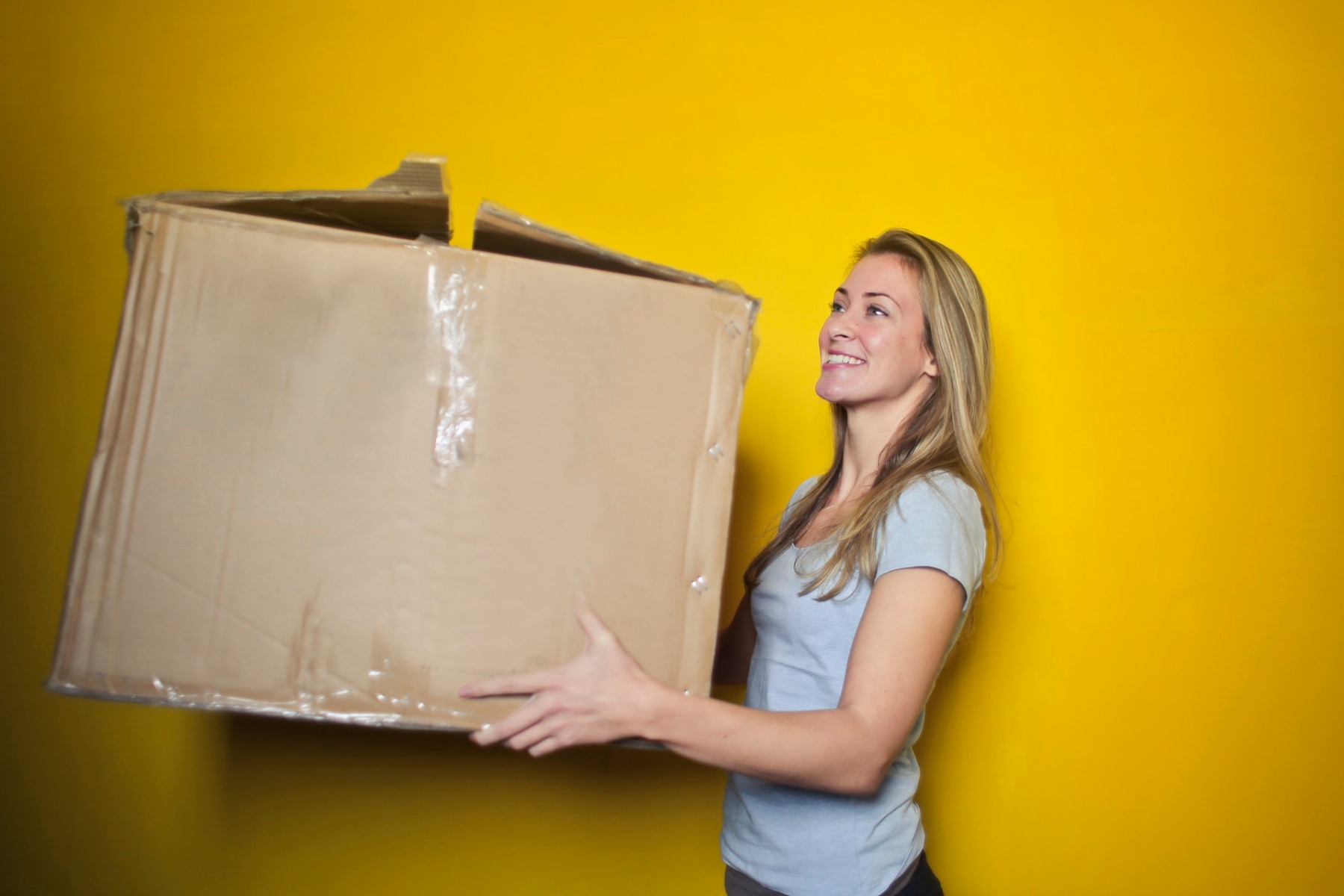 settling into your home woman carrying a box