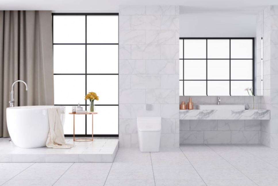 bathroom with white tiles, white bath, windows, vanity, toilet